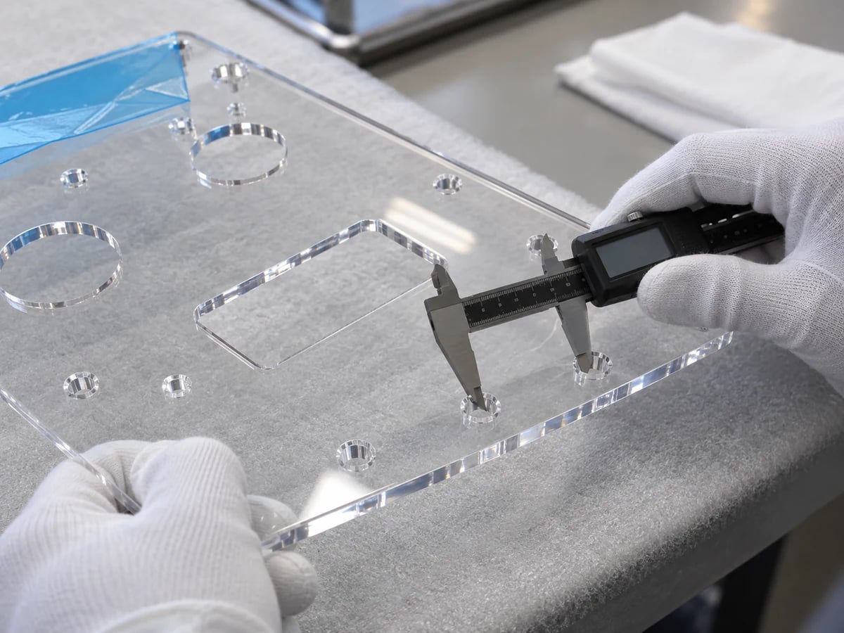 Illustrative caliper inspection of an acrylic instrument panel on a padded protected bench